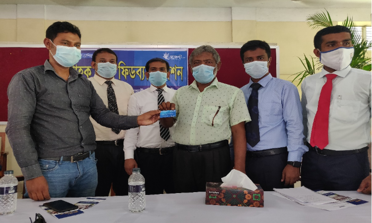 A farmer from Gaibandha receives a Fish Card as part of obtaining a loan from Bank Asia. Photo by Debasish Bhattacharjee/WorldFish